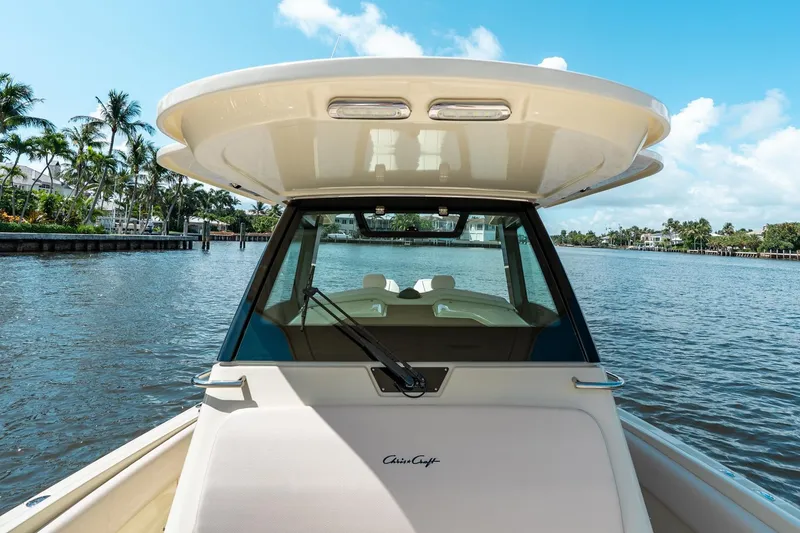Slide: The Image of 2024 Chris-Craft Catalina 30 boat on a scenic waterway with palm trees. - 16