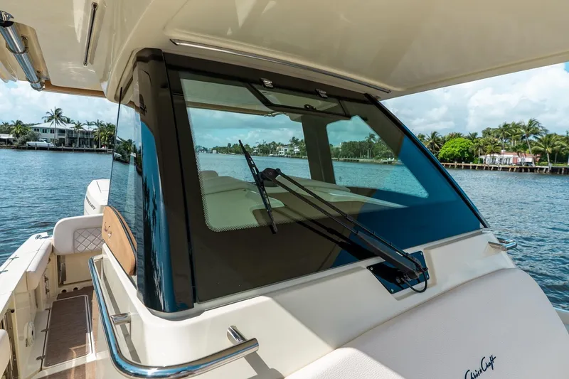Slide: The Image of 2024 Chris-Craft Catalina 30 boat with sleek windshield design on a sunny waterfront. - 17
