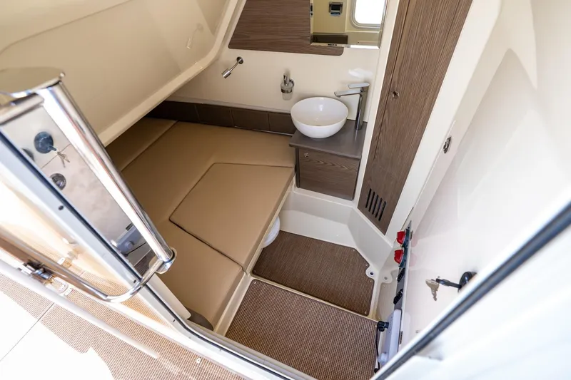 Slide: The Image of 2024 Chris-Craft Catalina 30 cabin interior with beige seating and modern sink. - 24