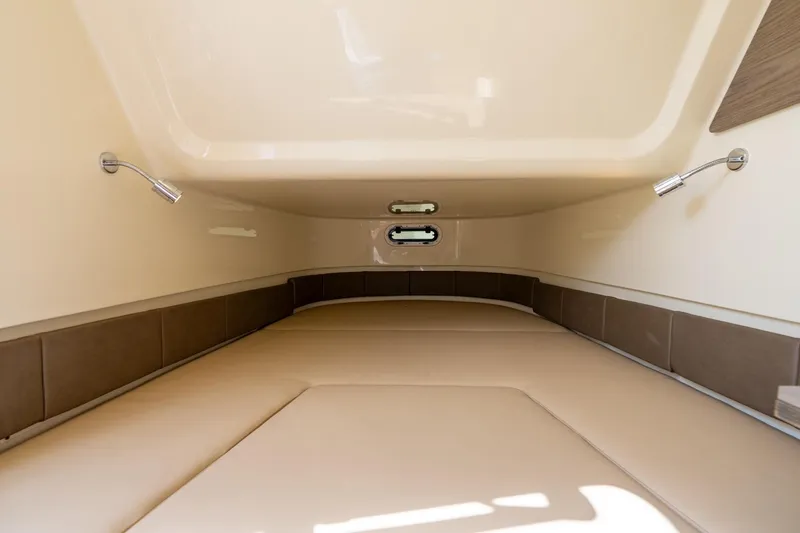 Slide: The Image of 2024 Chris-Craft Catalina 30 cabin interior with beige cushions and modern lighting. - 26