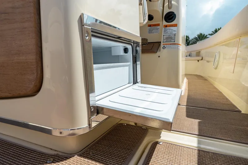 Slide: The Image of 2024 Chris-Craft Catalina 30 boat interior with open storage compartment, showcasing luxury design. - 27