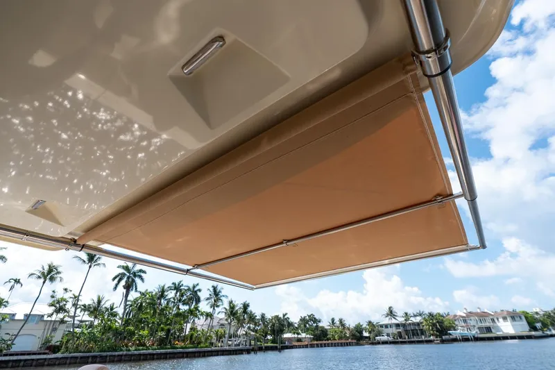 Slide: The Image of 2024 Chris-Craft Catalina 30 boat awning, providing shade on a sunny waterfront. - 33