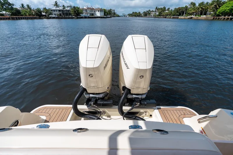 Slide: The Image of 2024 Chris-Craft Catalina 30 with dual Mercury outboard engines on a scenic waterway. - 37