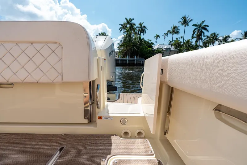 Slide: The Image of 2024 Chris-Craft Catalina 30 boat interior with luxurious seating and scenic waterfront view. - 38