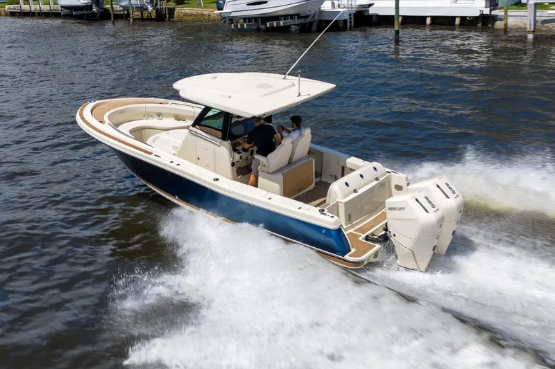 Slide: The Image of 2024 Chris-Craft Catalina 30 boat cruising on water with dual Mercury engines. - 4