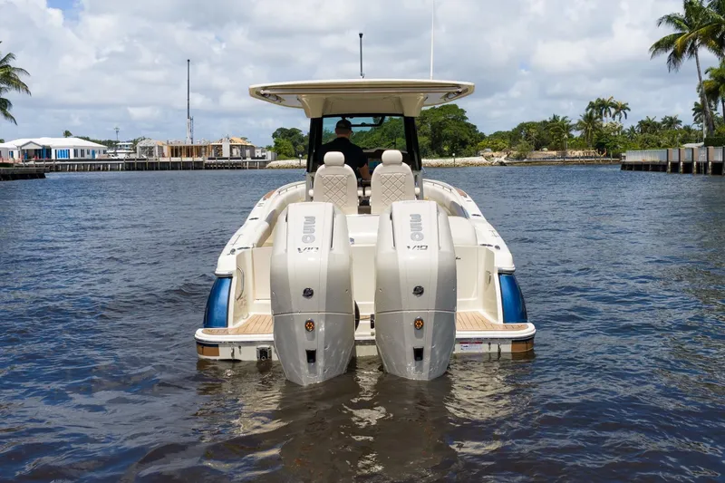 Slide: The Image of 2024 Chris-Craft Catalina 30 boat with dual engines on a sunny waterway. - 6