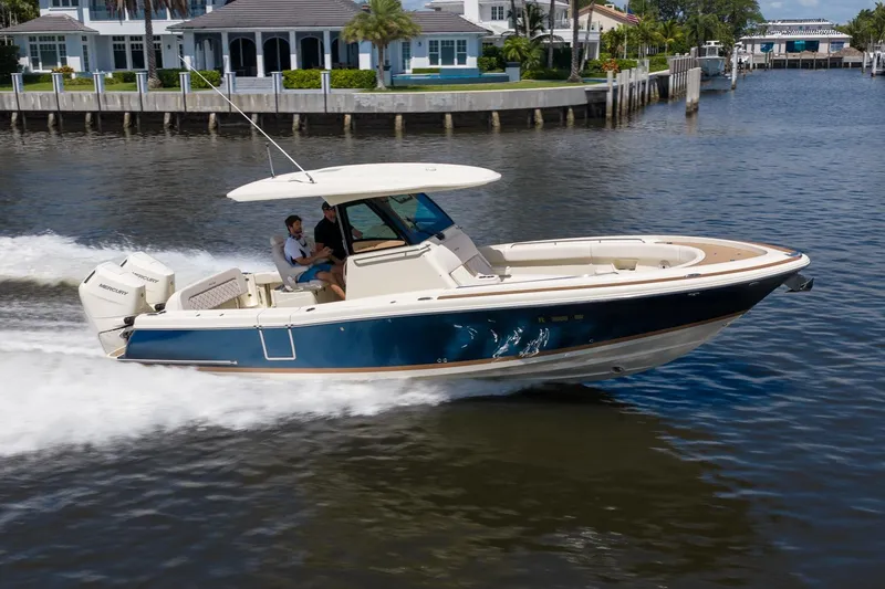 Slide: The Image of 2024 Chris-Craft Catalina 30 cruising on a scenic waterway, showcasing sleek design and performance. - 7