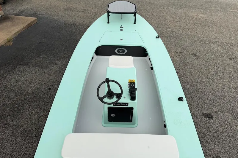 Slide: The Image of 2026 Chittum Skiffs 18 Laguna Madre Carbon boat, mint green, top view of cockpit and steering. - 10