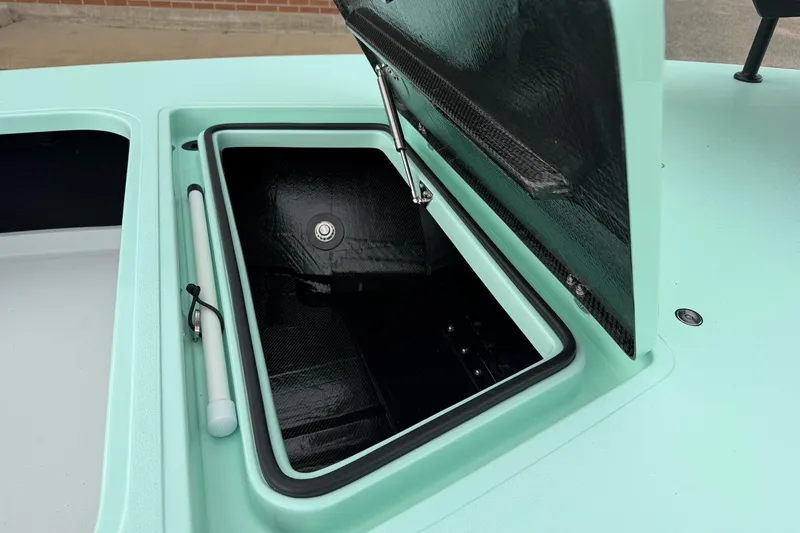 Slide: The Image of Open storage compartment on 2026 Chittum Skiffs 18 Laguna Madre Carbon boat. - 12