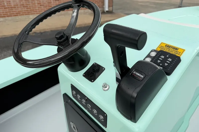 Slide: The Image of 2026 Chittum Skiffs 18 Laguna Madre Carbon boat console with Yamaha controls. - 17