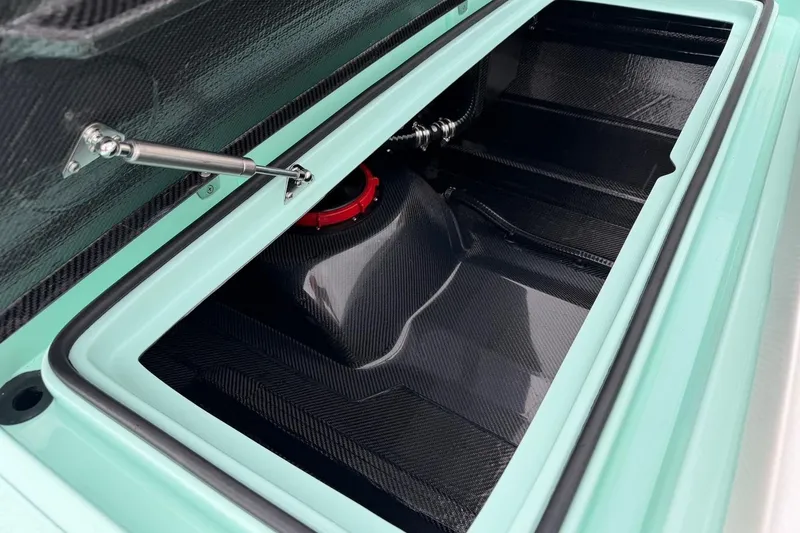 Slide: The Image of Open storage compartment of 2026 Chittum Skiffs 18 Laguna Madre Carbon boat. - 21