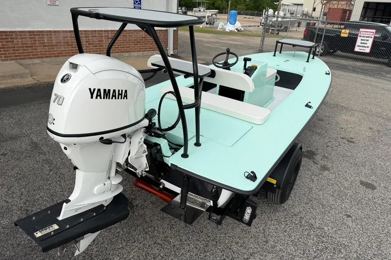 Slide: The Image of 2026 Chittum Skiffs 18 Laguna Madre Carbon with Yamaha 70 engine, parked outdoors. - 22