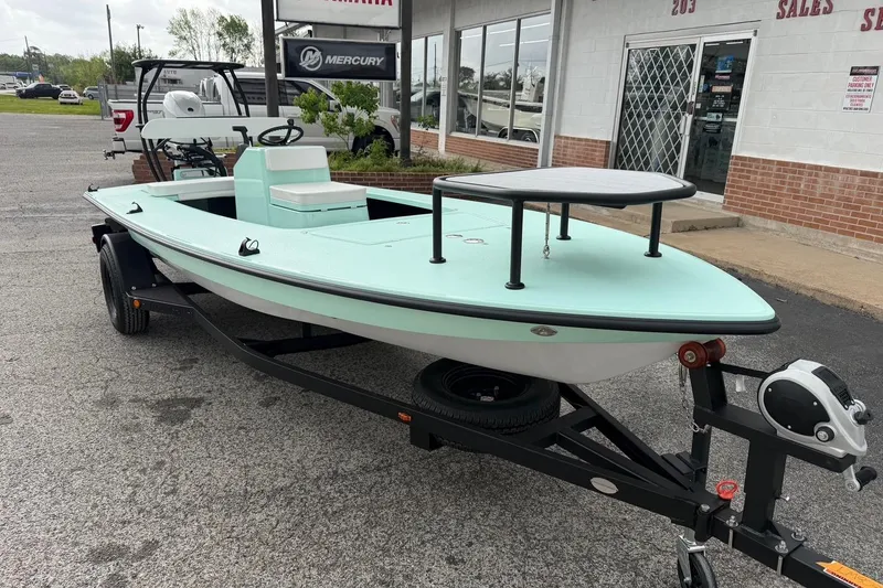 Slide: The Image of 2026 Chittum Skiffs 18 Laguna Madre Carbon boat on trailer, parked outside dealership. - 5