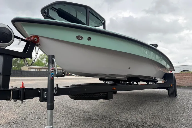 Slide: The Image of 2026 Chittum Skiffs 18 Laguna Madre Carbon boat on trailer, parked outdoors. - 6