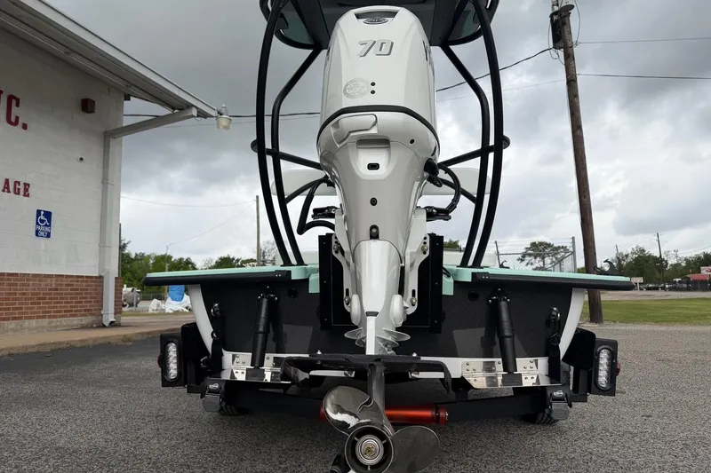 Slide: The Image of 2026 Chittum Skiffs 18 Laguna Madre Carbon with powerful outboard motor, parked outdoors. - 7