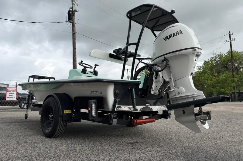 Slide: The Image of 2026 Chittum Skiffs 18 Laguna Madre Carbon with Yamaha engine on trailer, parked outdoors. - 8