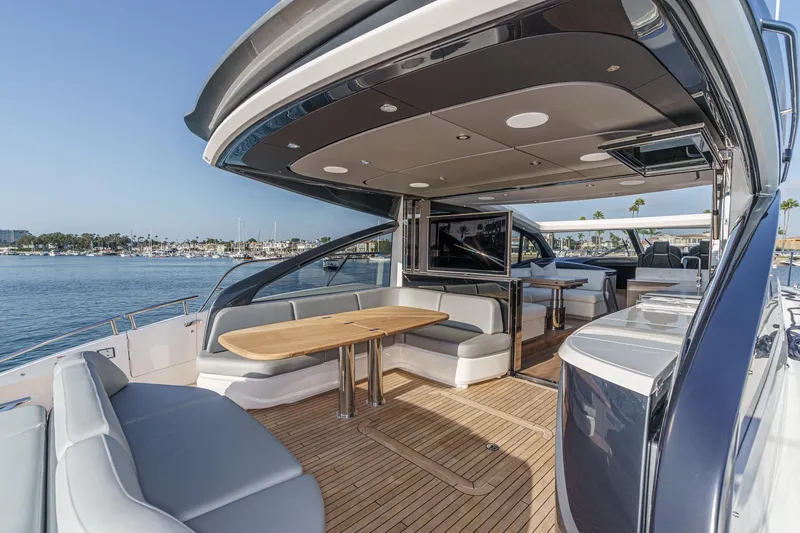 Slide: The Image of Luxurious 2026 Princess V55 yacht with elegant outdoor seating and scenic ocean view. - 19