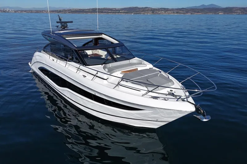 Slide: The Image of 2026 Princess V55 yacht cruising on calm blue waters. - 2