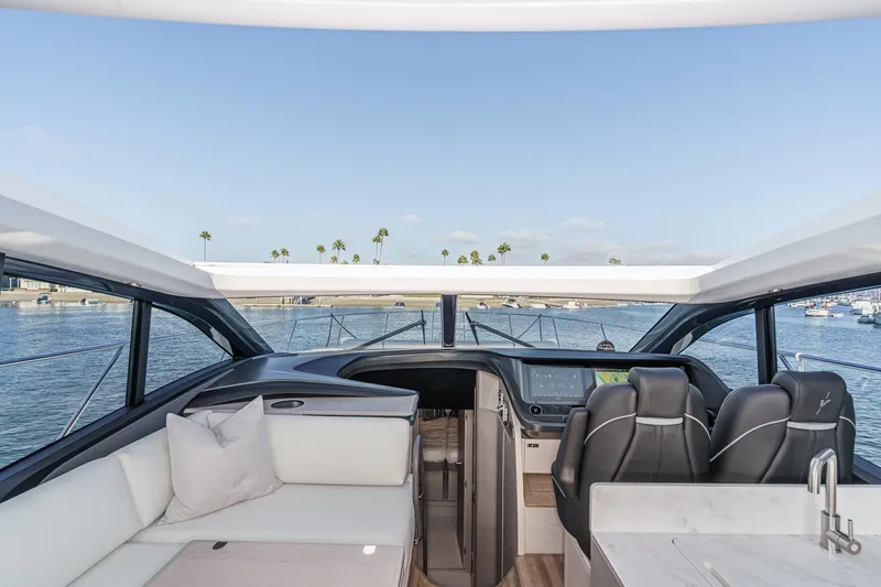 Slide: The Image of Interior view of 2026 Princess V55 yacht with luxurious seating and modern helm. - 42