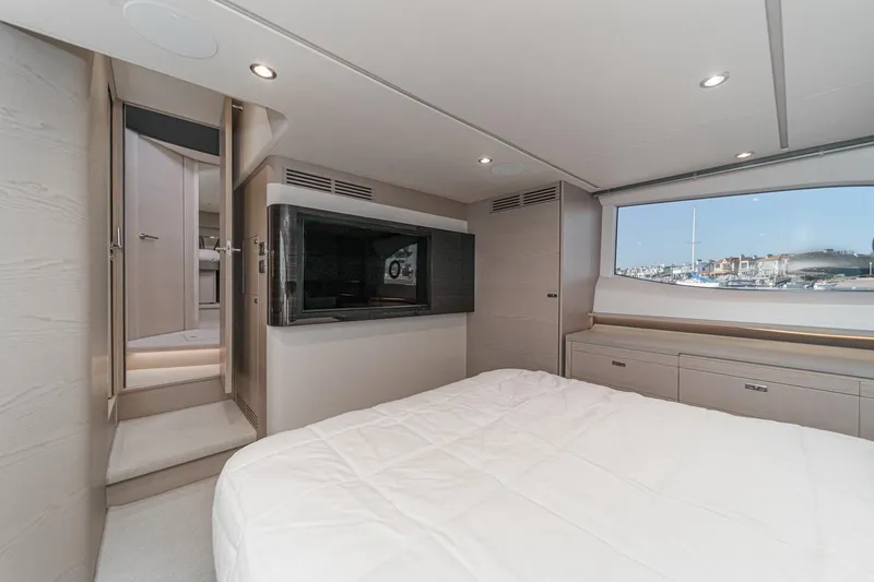 Slide: The Image of Luxurious interior of 2026 Princess V55 yacht with modern bedroom and scenic window view. - 50