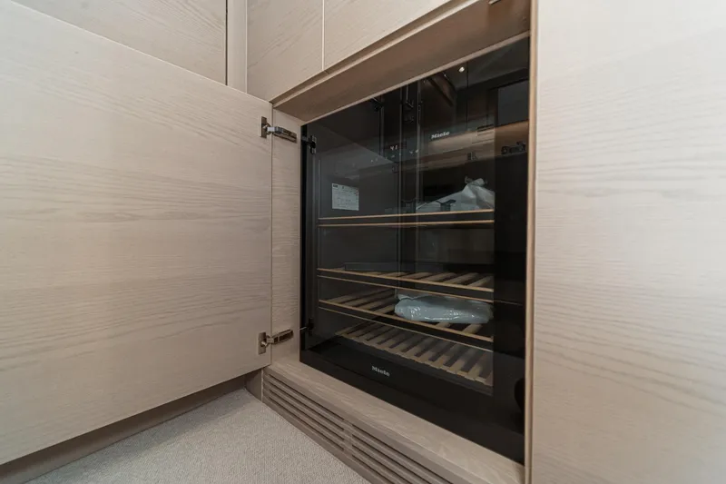 Slide: The Image of Modern wine cooler in a 2026 Princess V55 yacht interior. - 58