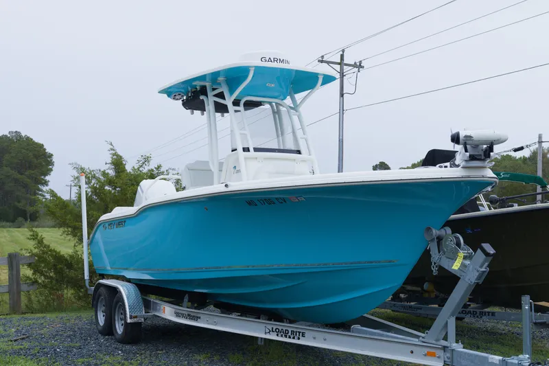 Slide: The Image of 2025 Key West 239 FS boat in vibrant blue on a trailer, ready for adventure. - 1