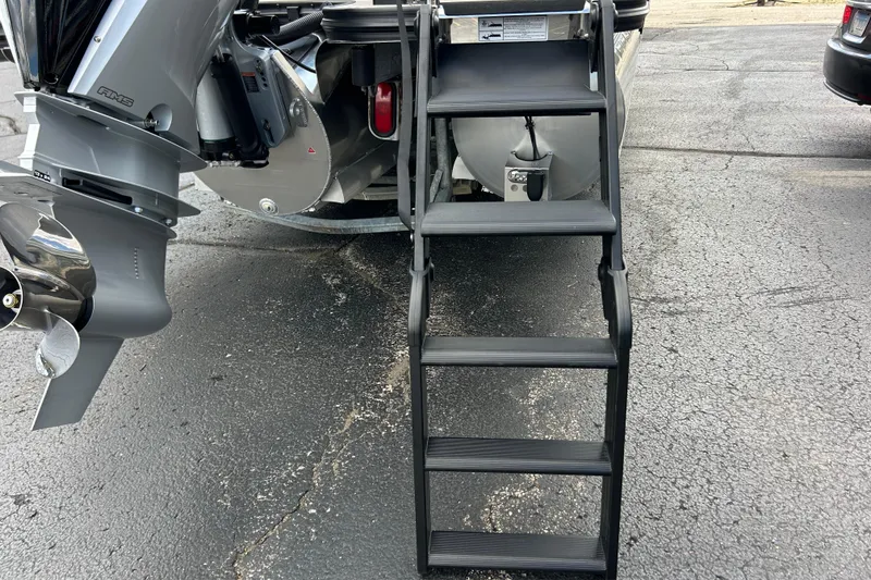 Slide: The Image of Boat motor and ladder of Alera M23L, 2026 model, on a paved surface. - 10