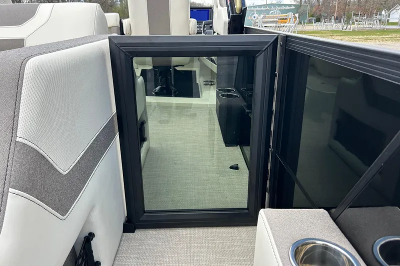 Slide: The Image of Interior of 2026 Alera M23L boat with modern seating and cup holders. - 11
