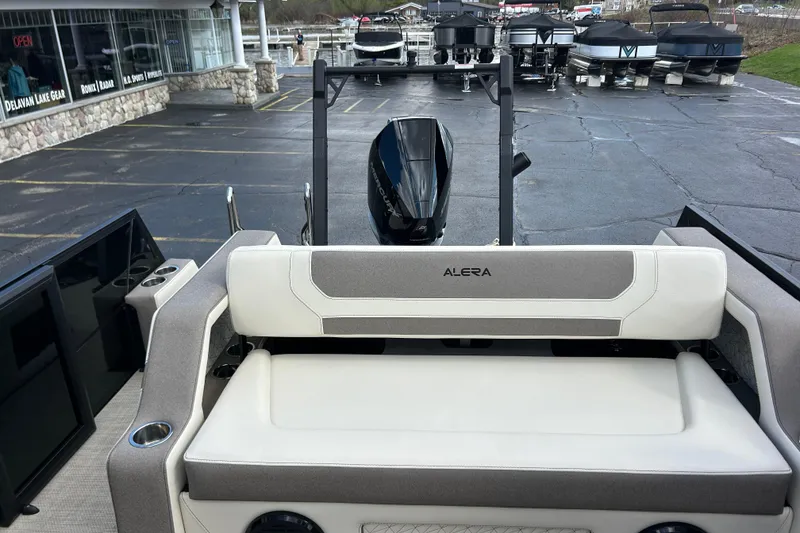 Slide: The Image of Alera M23L 2026 boat interior with seating, docked at a marina. - 19