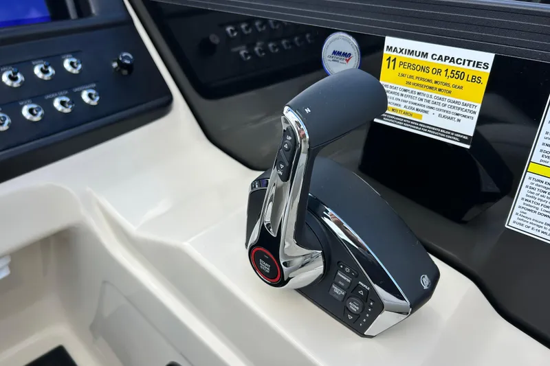 Slide: The Image of Control panel of 2026 Alera M23L boat with throttle lever and capacity label. - 21