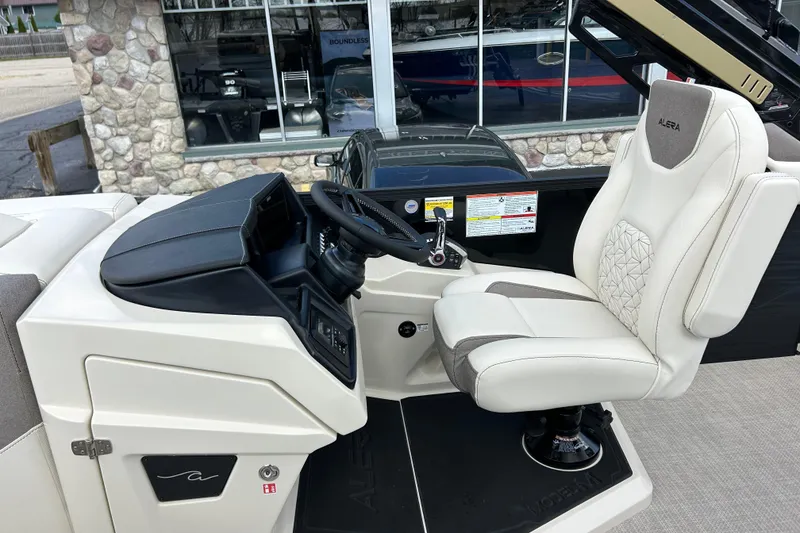 Slide: The Image of Captain's seat and helm of 2026 Alera M23L boat, featuring modern design and controls. - 22