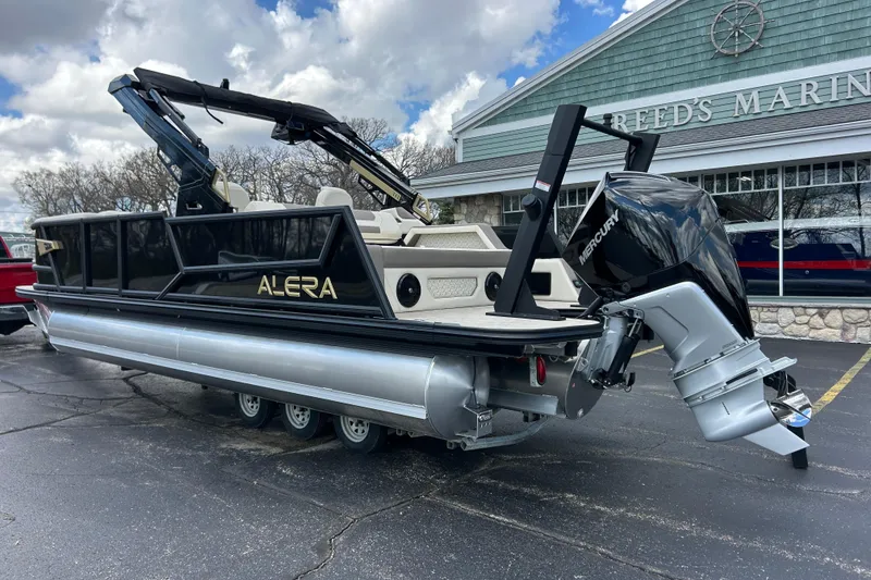 Slide: The Image of 2026 Alera M23L pontoon boat with Mercury outboard motor at marina. - 3