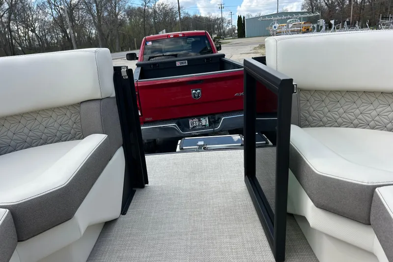 Slide: The Image of Interior of 2026 Alera M23L boat with red truck in background. - 31