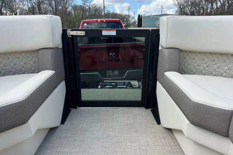 Slide: The Image of Interior view of 2026 Alera M23L boat with plush seating and glass door. - 32