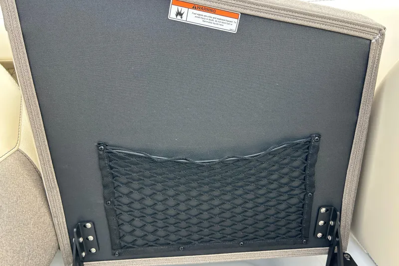 Slide: The Image of Back of Alera M23L seat with net pocket and warning label, 2026 model. - 34