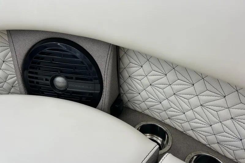 Slide: The Image of Luxurious Alera M23L 2026 interior with geometric upholstery, speaker, and cup holders. - 37