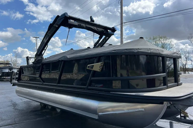 Slide: The Image of 2026 Alera M23L pontoon boat with canopy, parked outdoors under a cloudy sky. - 45