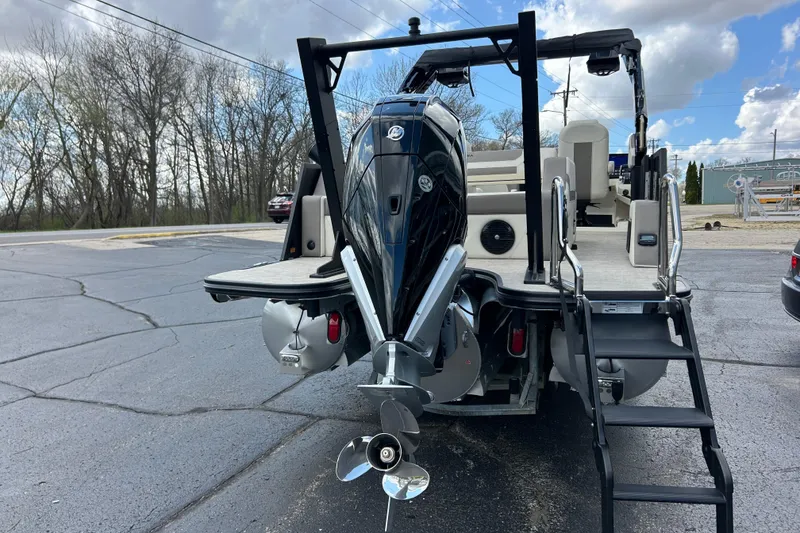 Slide: The Image of 2026 Alera M23L boat with powerful outboard motor and sleek design on a paved surface. - 8