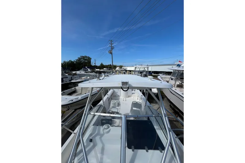 Slide: The Image of 2005 Aquasport 250 Explorer boat docked under clear blue sky. - 11