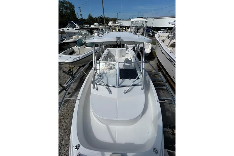 Slide: The Image of 2005 Aquasport 250 Explorer boat docked among other vessels. - 12