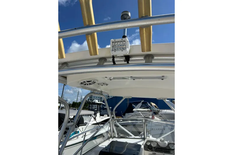 Slide: The Image of 2005 Aquasport 250 Explorer boat with T-top and mounted equipment. - 14
