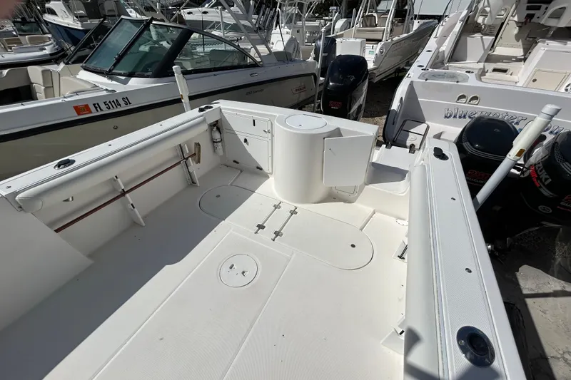 Slide: The Image of 2005 Aquasport 250 Explorer boat interior with seating and storage compartments. - 3