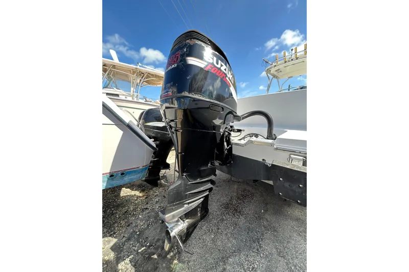 Slide: The Image of 2005 Aquasport 250 Explorer with Suzuki outboard motor under clear blue sky. - 5