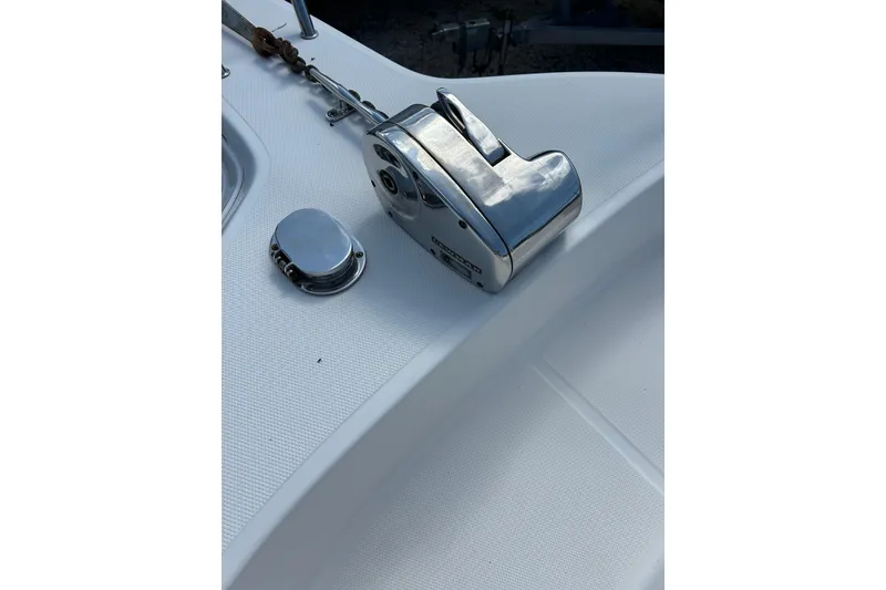 Slide: The Image of Close-up of a 2005 Aquasport 250 Explorer boat's anchor winch and deck. - 6