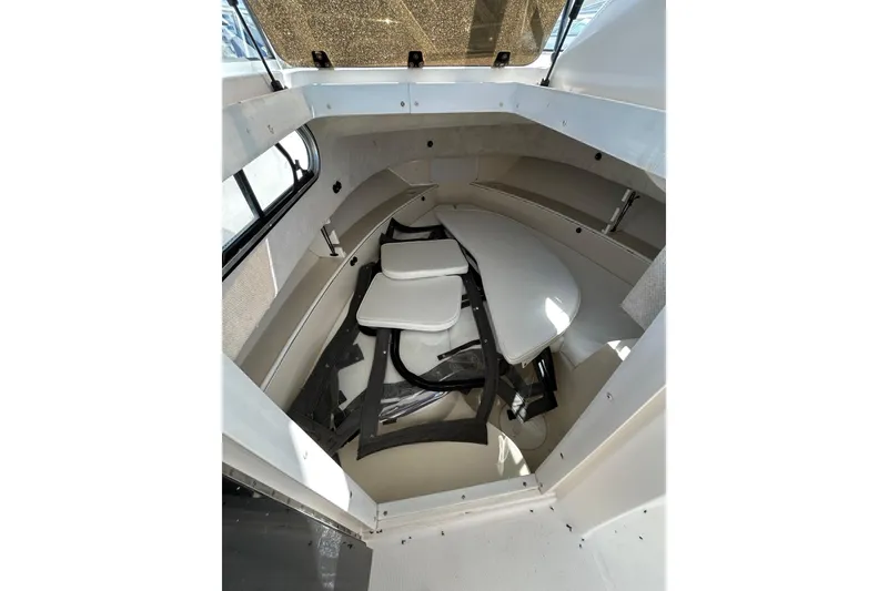 Slide: The Image of Interior cabin of 2005 Aquasport 250 Explorer boat with seating and table. - 7