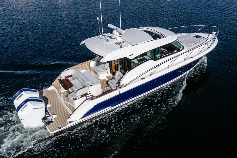 Slide: The Image of 2026 Tiara Yachts 43LE cruising on open water, showcasing sleek design and powerful engines. - 11