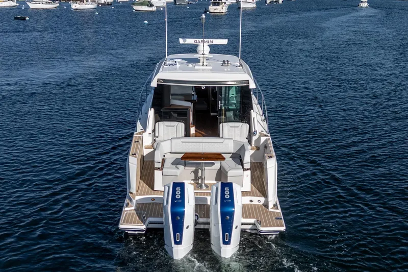 Slide: The Image of 2026 Tiara Yachts 43LE cruising on open water, showcasing dual outboard engines. - 13