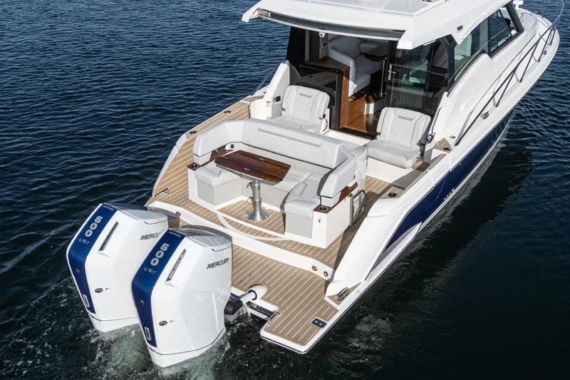 Slide: The Image of 2026 Tiara Yachts 43LE luxury boat with dual Mercury engines on water. - 15