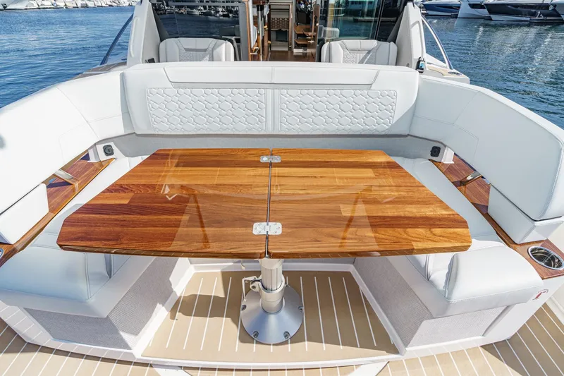 Slide: The Image of Luxurious seating area on 2026 Tiara Yachts 43LE with elegant wooden table. - 24