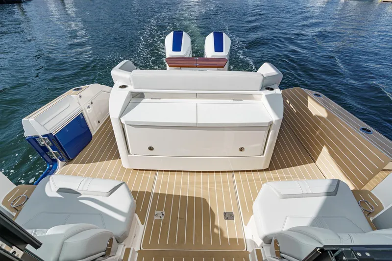 Slide: The Image of 2026 Tiara Yachts 43LE luxury boat deck with seating, on calm water. - 26